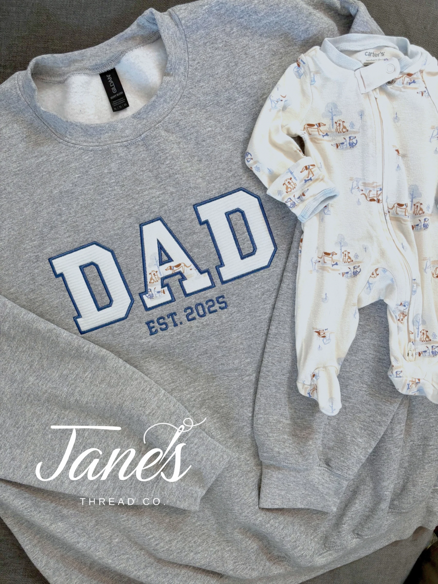 DAD text on a grey sweatshirt made from embroidered baby outfits