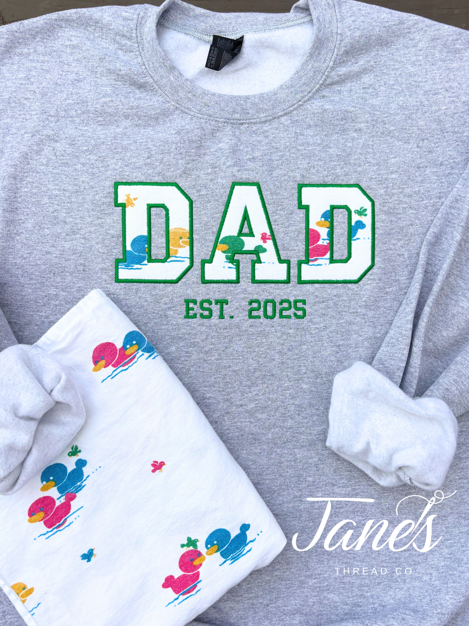 DAD text on a grey sweatshirt made from baby hospital blanket