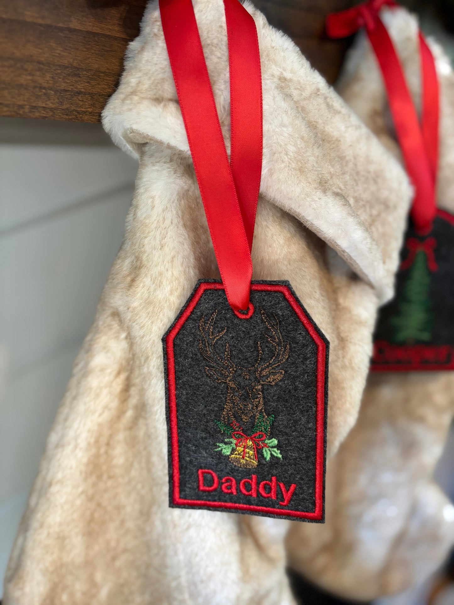 Christmas stocking with a 'Daddy' tag on a beige background